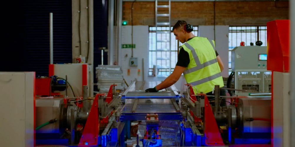 staging board inserting rungs factory worker